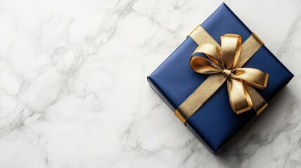 Poster - Elegant blue gift box with golden ribbon on a marble background creating a sophisticated holiday or celebration gift theme with copy space.