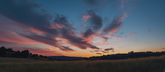 Wall Mural - dramatic sunset over a serene landscape with colorful clouds and a peaceful meadow atmosphere