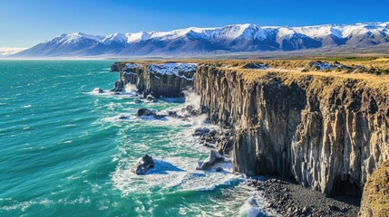 Aufkleber - Volcanic cliffs meet vibrant ocean waves with snow-capped mountains under a clear sky showcasing stunning natural beauty.