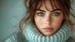 © ArtificialHorizons - Young woman with wavy hair in a cozy sweater expressing sadness against a minimalist blurred background perfect for text overlays.