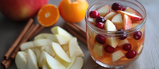 Poster - Sangria with apple cranberry and orange garnished with fresh fruit and cinnamon sticks on a wooden table setting