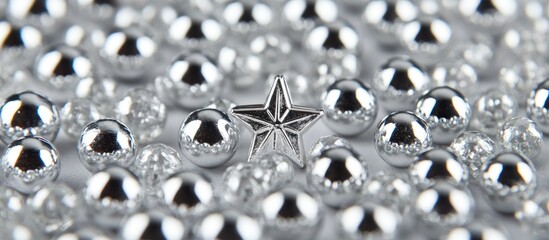 Poster - Glittering silver beads and star on a textured paper background creating an elegant macro scene perfect for seasonal or festive themes