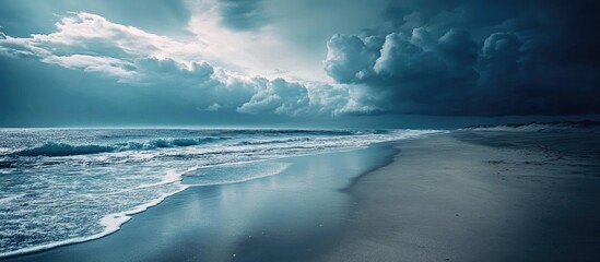 Poster - Dramatic coastal landscape featuring rolling waves and turbulent skies under a moody atmosphere with reflections on wet sand