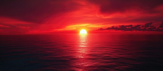 Poster - Stunning sunset viewed from an airplane showcasing a dramatic red sky over the tranquil ocean reflecting warm hues of twilight.