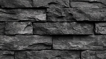 Poster - Dark gray stone wall texture with a rough, uneven surface ideal for architectural backgrounds or design projects.
