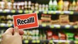 © Jack - Hand holding a 'Recall' sticker on a packaged food item, highlighting the importance of food safety and consumer protection in product management.