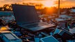 © Panuwat - Laptop computer sitting top pile electronic devices is ewaste of discarded