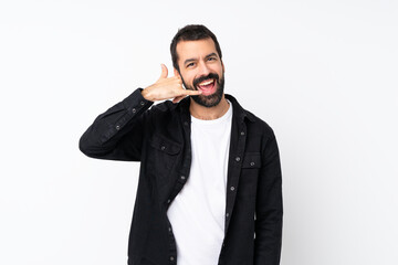 Wall Mural - Young man with beard over isolated white background making phone gesture. Call me back sign