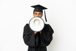 © luismolinero - African American university graduate man over isolated white background shouting through a megaphone
