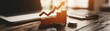 © NingPhattraphorn - A financial growth concept featuring a graph with an upward trend, coins, and a laptop in a workspace, symbolizing success and investment, with blank space for text