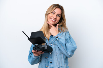 Canvas Print - Young Uruguayan woman holding a drone remote control isolated on white background happy and smiling