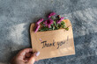 © ADDICTIVE STOCK - Envelope with flowers and handwritten thank you message