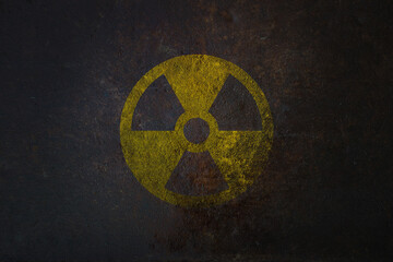 radioactive (ionizing radiation) round yellow and black danger symbol painted on a massive rusty met