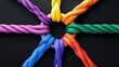 © Flowaiart - Colorful Decorative Ropes Intertwined in a Circle on Black Background