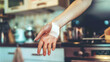 © Jafree - Close-up of a woman’s hand with a bandage on the palm in a kitchen setting. Concept of first aid, injury care, and home safety