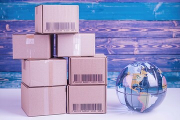 Poster - A stack of cardboard boxes with barcodes  symbolizing global e commerce and shipping.