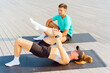 © muse studio - Fitness training session with partner outdoors on yoga mats in bright sunlight at a waterfront location