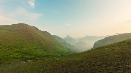 Wall Mural - Ba Guang grass hill, mountain range with foggy flowing in the morning