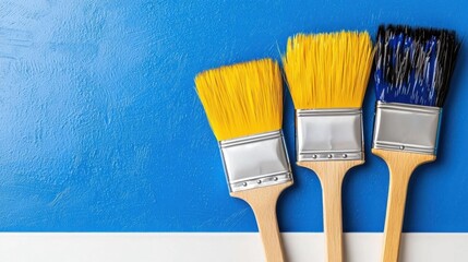 A photostock of three colorful paintbrushes with vibrant paint tips, standing upright, isolated on a white background for artistic themes. High Quality