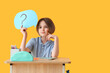 © Pixel-Shot - Thoughtful schoolboy with stationery and speech bubble sitting on desk against yellow background