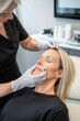 © Erik González - A woman is getting a procedure done on her face