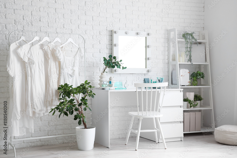 Interior of makeup room with table, clothes rack and shelf unit