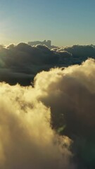 Wall Mural - flying above the clouds. aerial view of clouds and morning sun. traveling by air perfect background.