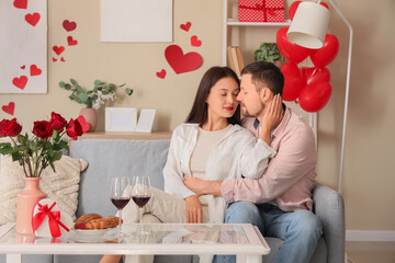 Canvas Print - Young couple sitting at home on Valentine's Day