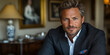 © sommersby - A well-groomed man poses confidently indoors, showcasing his tailored jacket and thoughtful expression amidst elegant decor and artwork