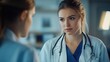 © Tahir AI - A young female doctor consulting with a colleague in her office, both standing.