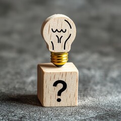 Poster - Conceptual of creative idea and innovation. Hand picked wooden cube block with head human symbol and light bulb icon and question mark symbol