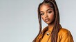 © Raul - A beautiful young Black woman with long braided hair poses confidently in a mustard-colored jacket.