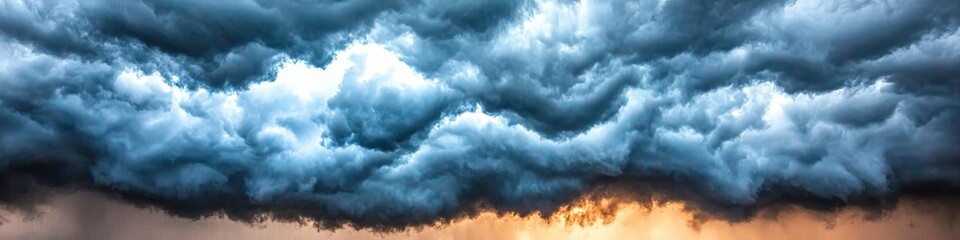 dramatic storm clouds gather, casting a deep blue hue against the soft glow of the setting sun.