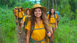 © Elena - Young hikers in yellow gear exploring a lush trail surrounded by nature during a sunny day, radiating joy and adventure with friends