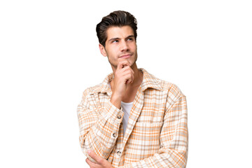 Wall Mural - Young handsome caucasian man over isolated background thinking an idea while looking up