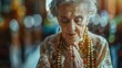 © ABIDZAR ALFAREZ - Elderly woman with eyes closed, praying.