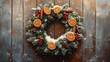 © anatolii - Festive wreath adorned with dried oranges, pine cones, and red berries set against a rustic wooden background during winter