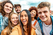 © charmedlightph - Laughing multicultural friends taking selfie picture with smart mobile phone outside - Happy young multiracial people smiling together at camera -Technology and diversity youth culture concept
