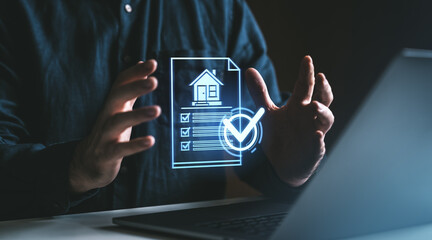 Poster - Hands holding virtual document with checklist and house icon near laptop on dark background.