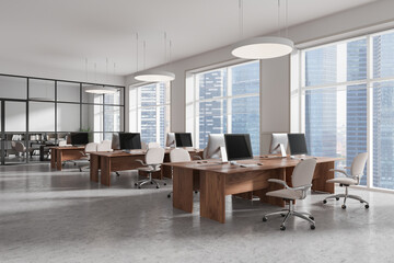Poster - modern open office space with wooden desks, ergonomic chairs, and large windows overlooking city sky