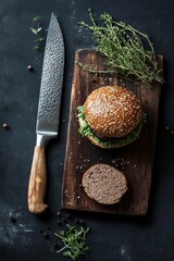 Wall Mural - Delicious burger on a wooden cutting board with fresh herbs and a knife