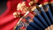 Close Up of a Traditional Chinese Fan Featuring Intricate Floral and Decorative Designs on a Vibrant Background