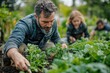 © Roman - People working in a garden together in the daytime