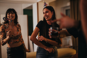 Poster - A group of friends joyfully celebrating a birthday with laughter and fun in a cozy living room. Captures the spirit of friendship and happiness during a special occasion.