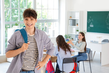 Canvas Print - Male teenage student with backpack in classroom