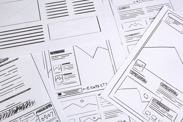 Leinwandbilder - Developing UI design. Sketches of website wireframes as background, above view