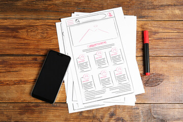 Leinwandbilder - Developing UI design. Sketches of website wireframes, felt pen and smartphone on wooden table, top view