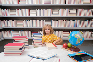 Fototapete - School and students in classroom. Education kids. Child pupil student in the school class. Studying and learning concept. School boy in the library near school supplies. Kid learn geography with globe