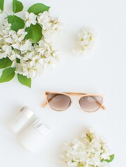 Leinwandbilder - Bright and cheerful summer accessories arranged on a white background include sunglasses and sunscreen, surrounded by lovely flowers. Generative AI