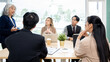 © Kittipong - Executives are having a meeting with employees to discuss business planning in a conference room.